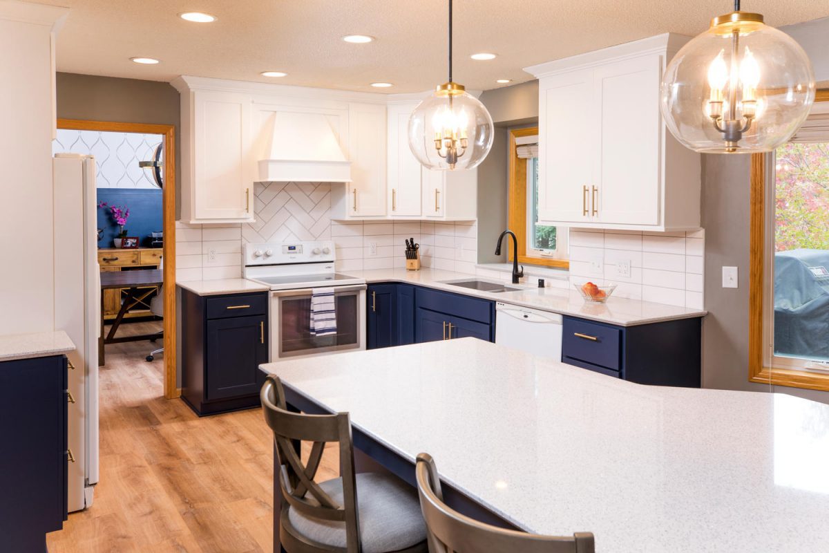 Modern kitchen with white wall kitchen cabinets and under-the-counter dark blue kitchen cabinets.